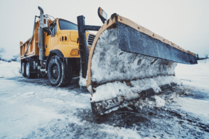 Snow plow parked on highway