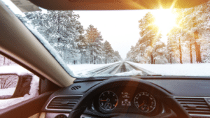 person driving in winter weather looking out windshield