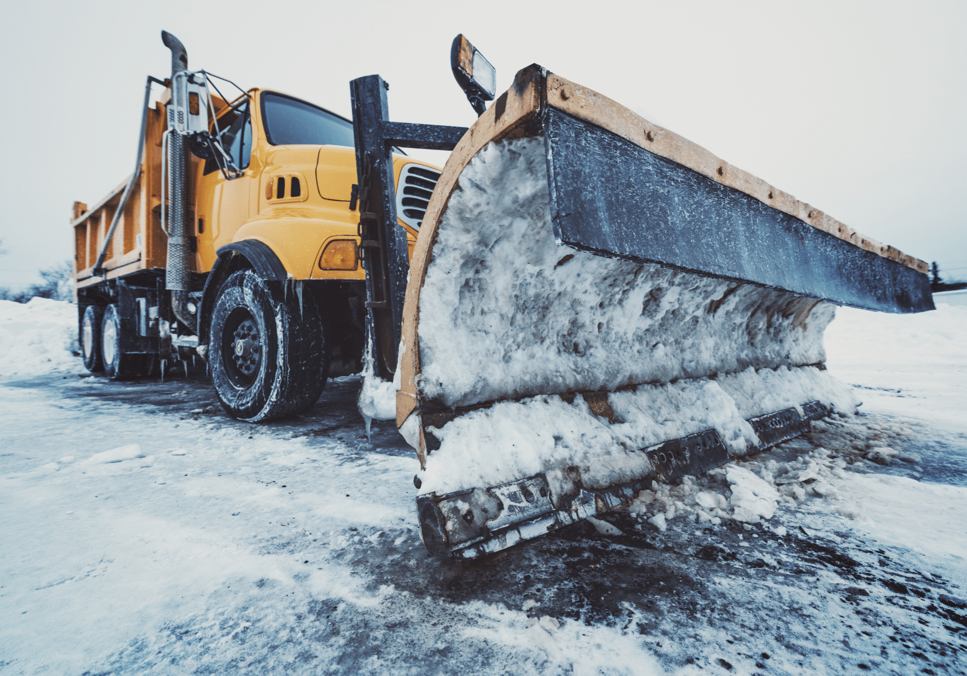 Snow plow parked on highway